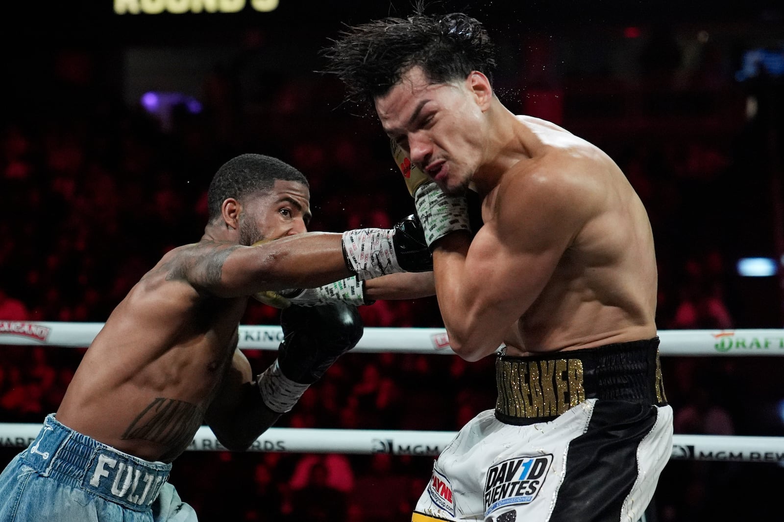 Stephen Fulton Jr., left, hits Brandon Figueroa in a featherweight title boxing match Saturday, Feb. 1, 2025, in Las Vegas. (AP Photo/John Locher)