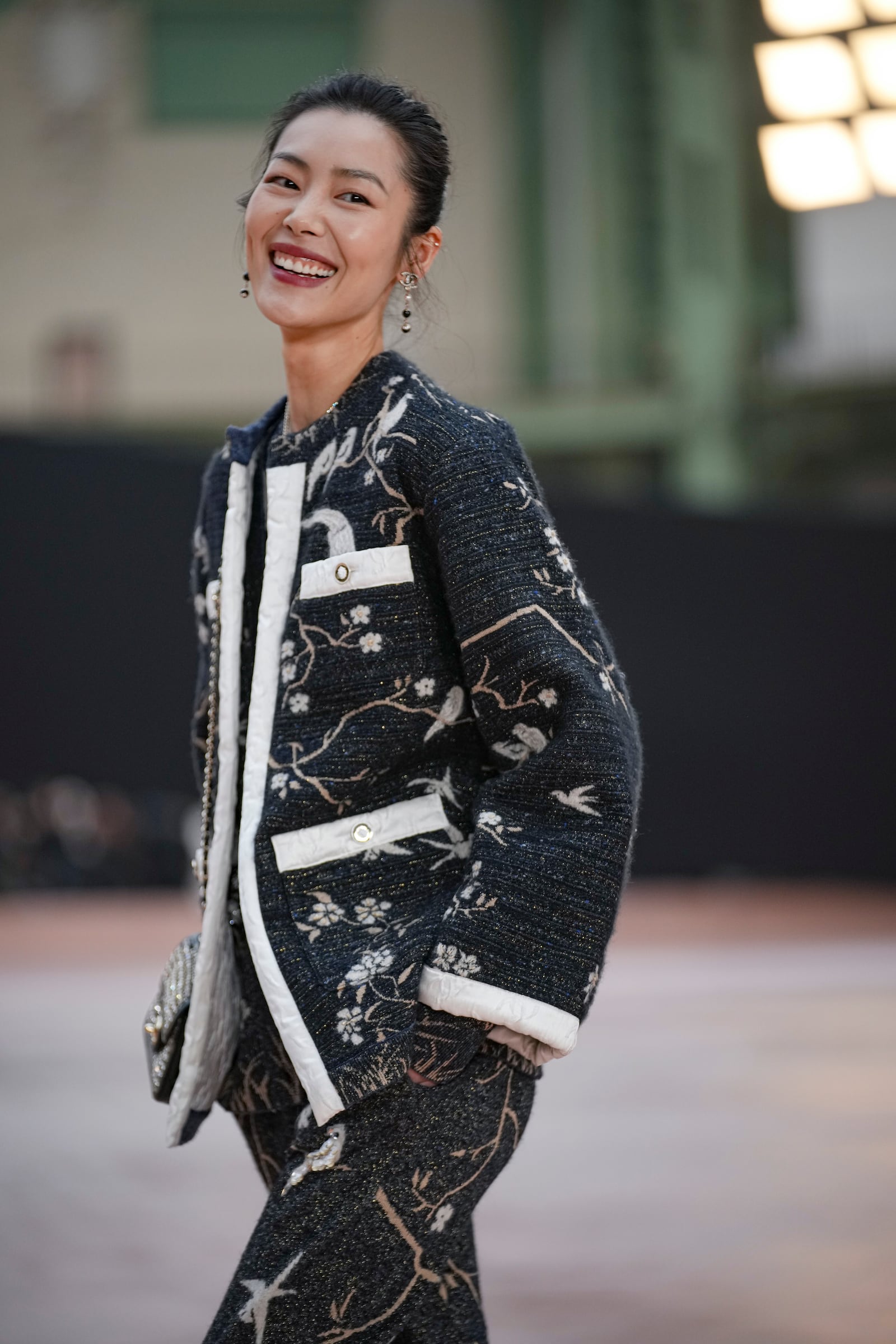 Liu Wen arrives for the the Chanel Fall/Winter 2025-2026 Womenswear collection presented Tuesday, March 11, 2025. in Paris. (AP Photo/Christophe Ena).