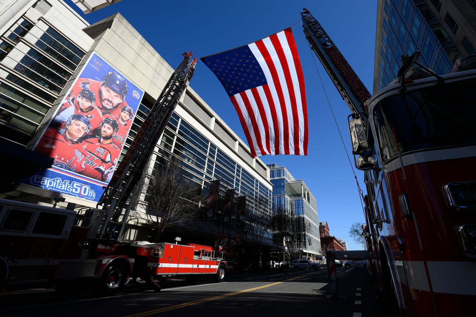 An American flag is flown outside of Capital One Arena before the Legacy on Ice event, a figure skating tribute to support the families and loved ones affected by the tragic January 29th aviation incident, Sunday, March 2, 2025, in Washington. (AP Photo/Nick Wass)