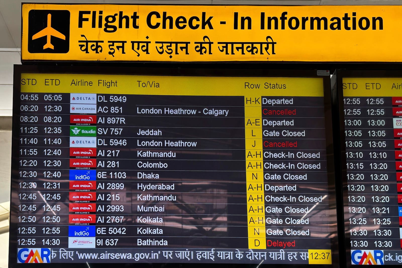 A flight information screen shows cancelled flights destined for the Heathrow Airport in London, at the Indira Gandhi International Airport, in New Delhi, India, Friday, March 21, 2025. (AP Photo/Shonal Ganguly)