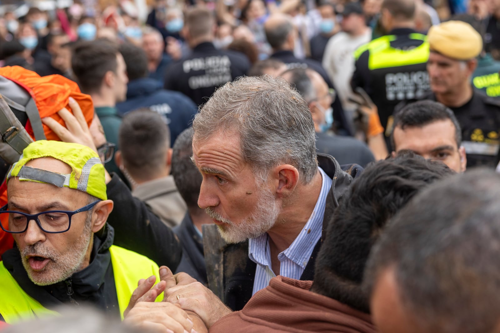 Spain's King Felipe VI speaks with people amidst angry Spanish flood survivors in Paiporta, near Valencia, Spain, Sunday Nov. 3, 2024. (AP Photo/David Melero)