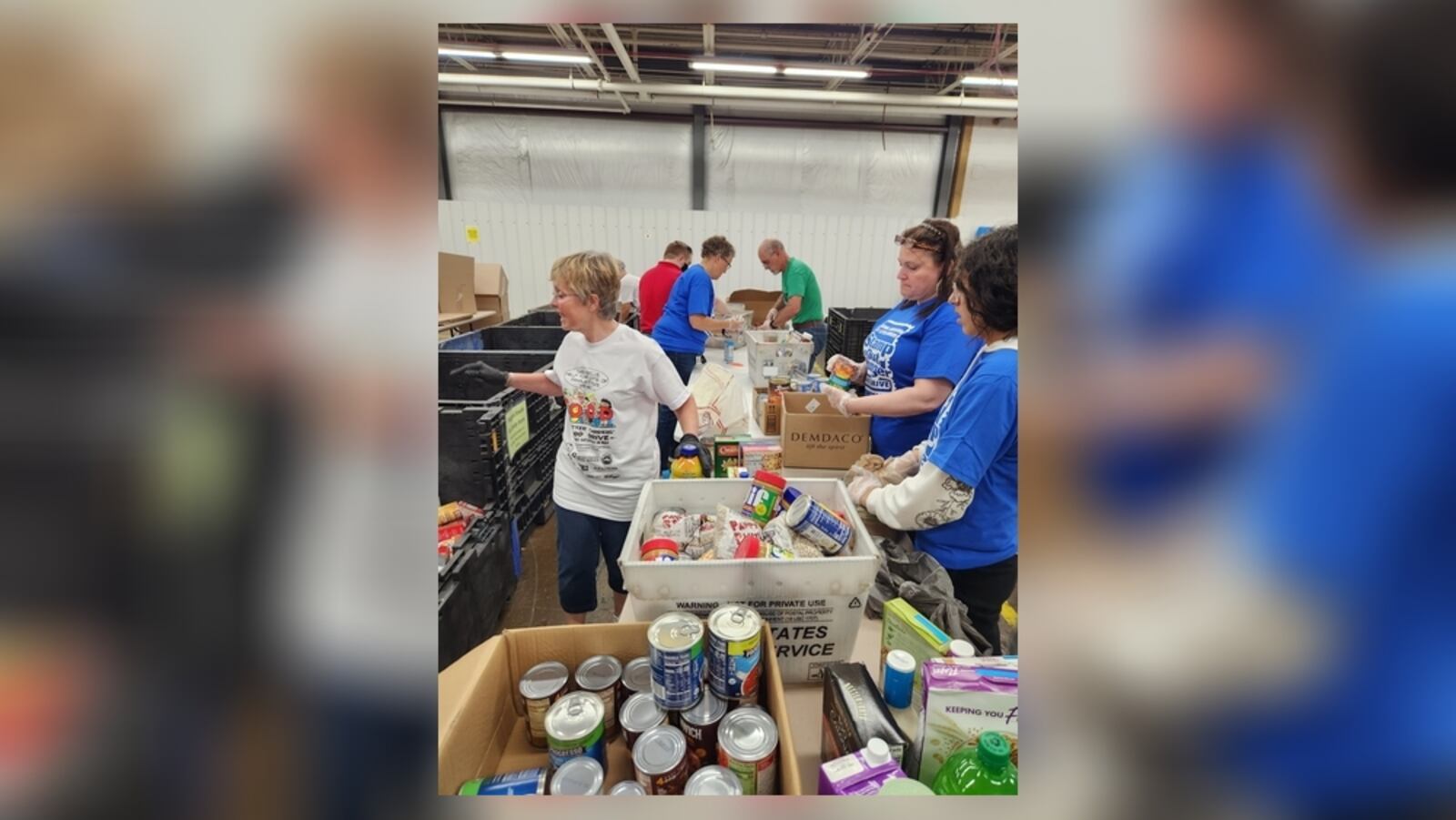 Second Harvest Food Bank staff, volunteers, and Letter Carriers receive and sort donated food during the 2023 Stamp Out Hunger food drive. Contributed