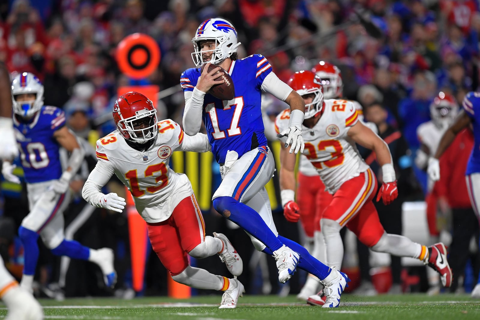 FILE - Buffalo Bills quarterback Josh Allen (17) avoids Kansas City Chiefs safety Nazeeh Johnson (13) as he runs for a touchdown during the second half of an NFL football game in Orchard Park, N.Y., Sunday, Nov. 17, 2024. (AP Photo/Adrian Kraus, File)