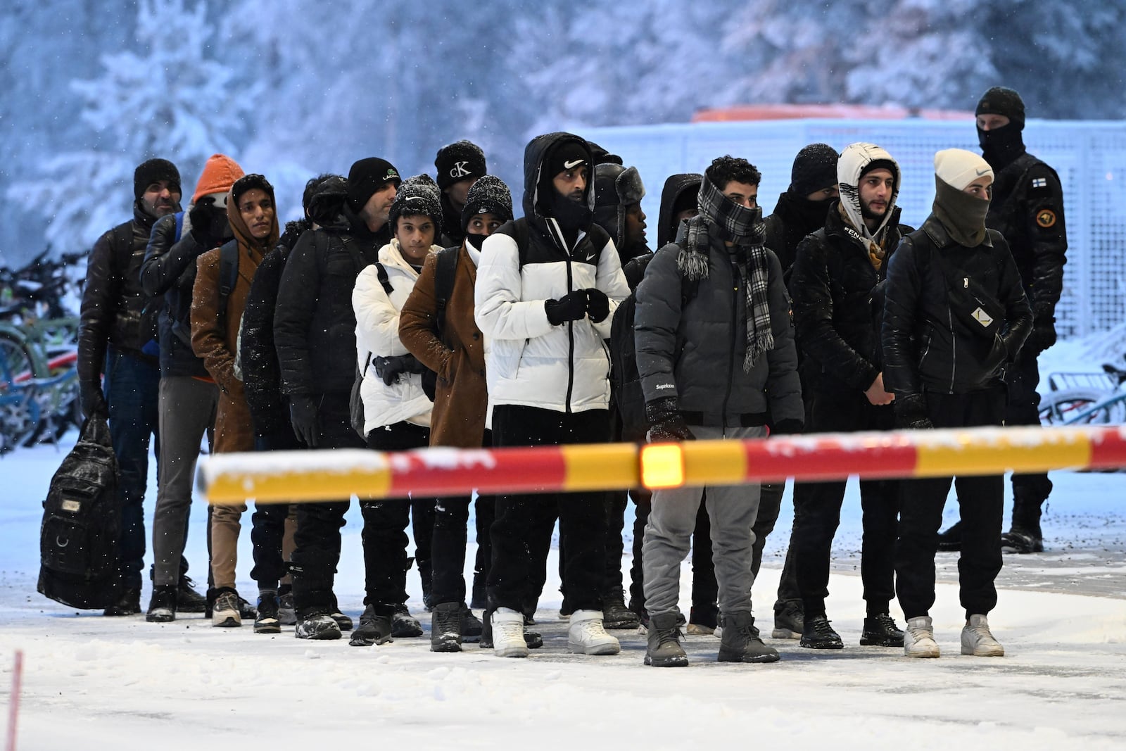 FILE - Migrants arrive at the international border crossing between Finland and Russia, in Salla, Finland, Nov. 23, 2023. (Jussi Nukari/Lehtikuva via AP, File)