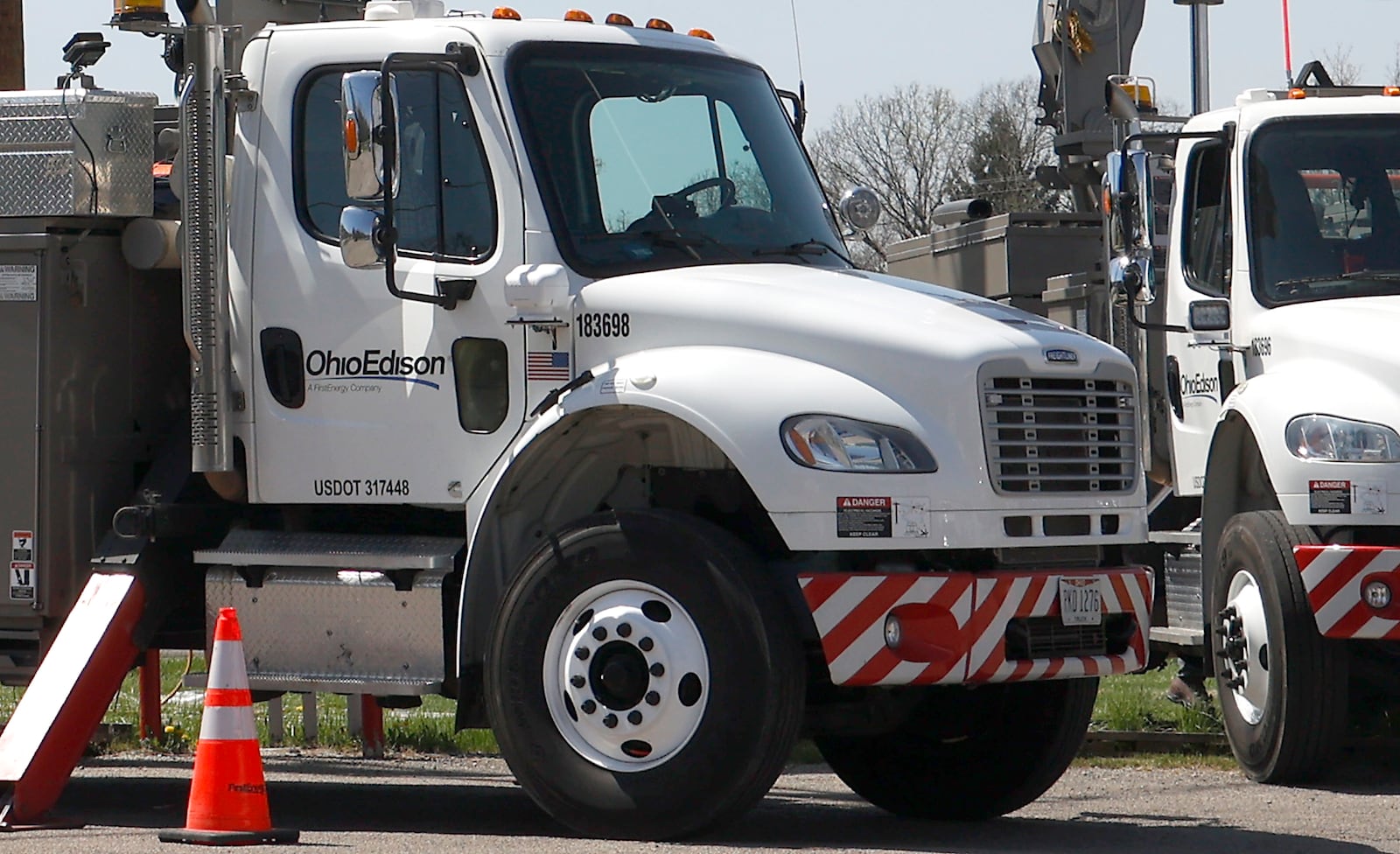 An Ohio Edison crew works on the power lines at the intersection of Urbana Road and Moorefield Road Wednesday, April 19, 2023. BILL LACKEY/STAFF