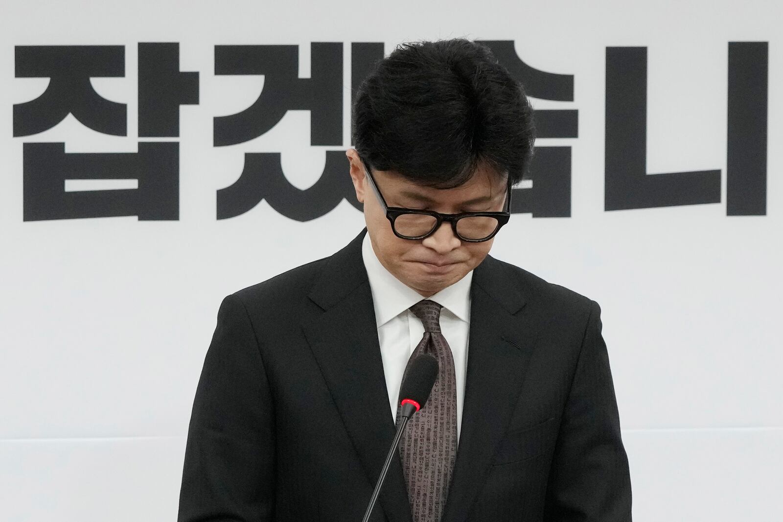 South Korea's ruling People Power Party leader Han Dong-hun reacts during a news conference to announce his resignation after President Yoon Suk Yeol's parliamentary impeachment, at the National Assembly in Seoul, South Korea, Monday, Dec. 16, 2024. (AP Photo/Ahn Young-joon)