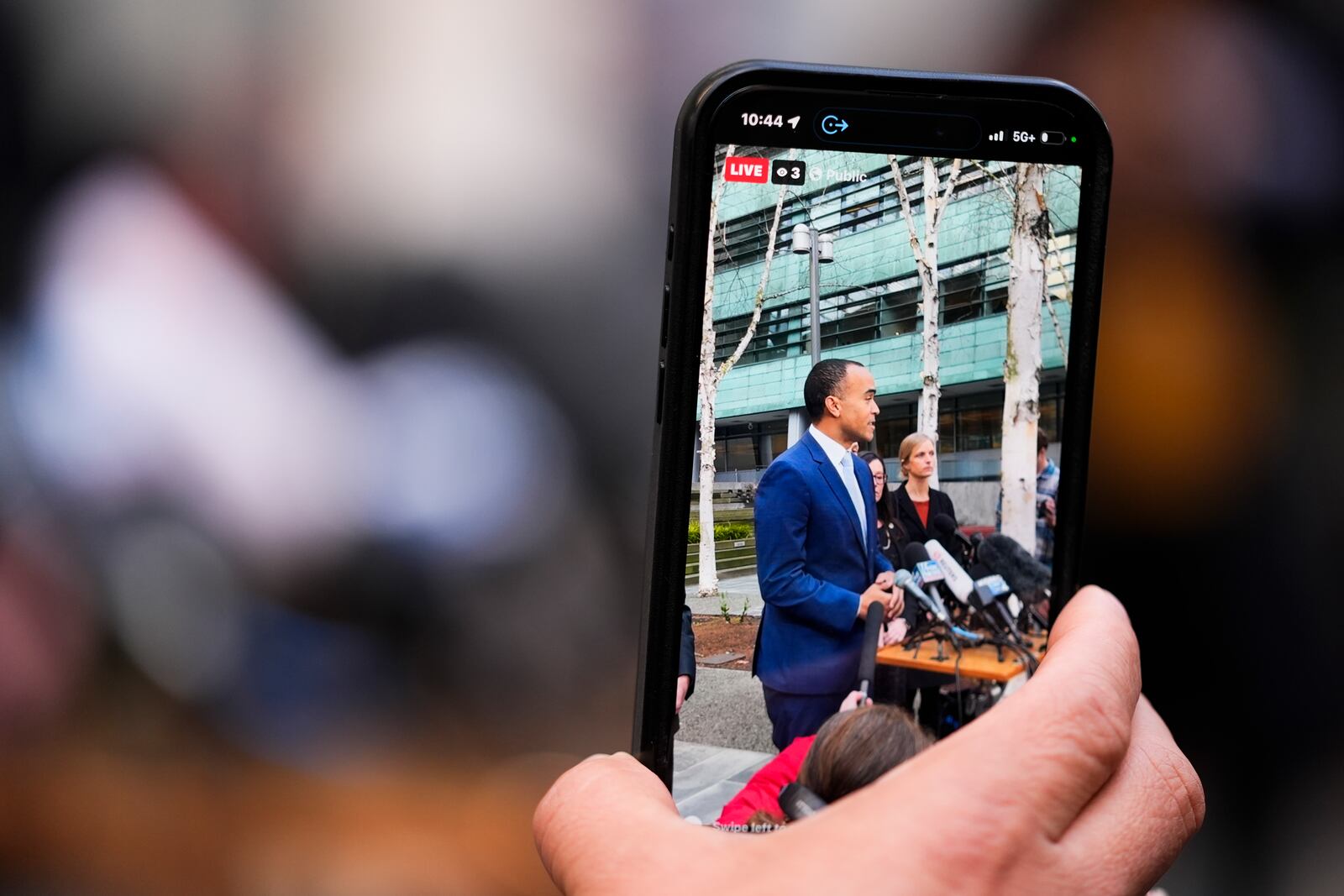 A person films Washington Attorney General Nick Brown as he speaks during a press availability after a federal judge temporarily blocked President Donald Trump's executive order aimed at ending birthright citizenship in a case brought by the states of Washington, Arizona, Illinois and Oregon, Thursday, Jan. 23, 2025, in Seattle. (AP Photo/Lindsey Wasson)