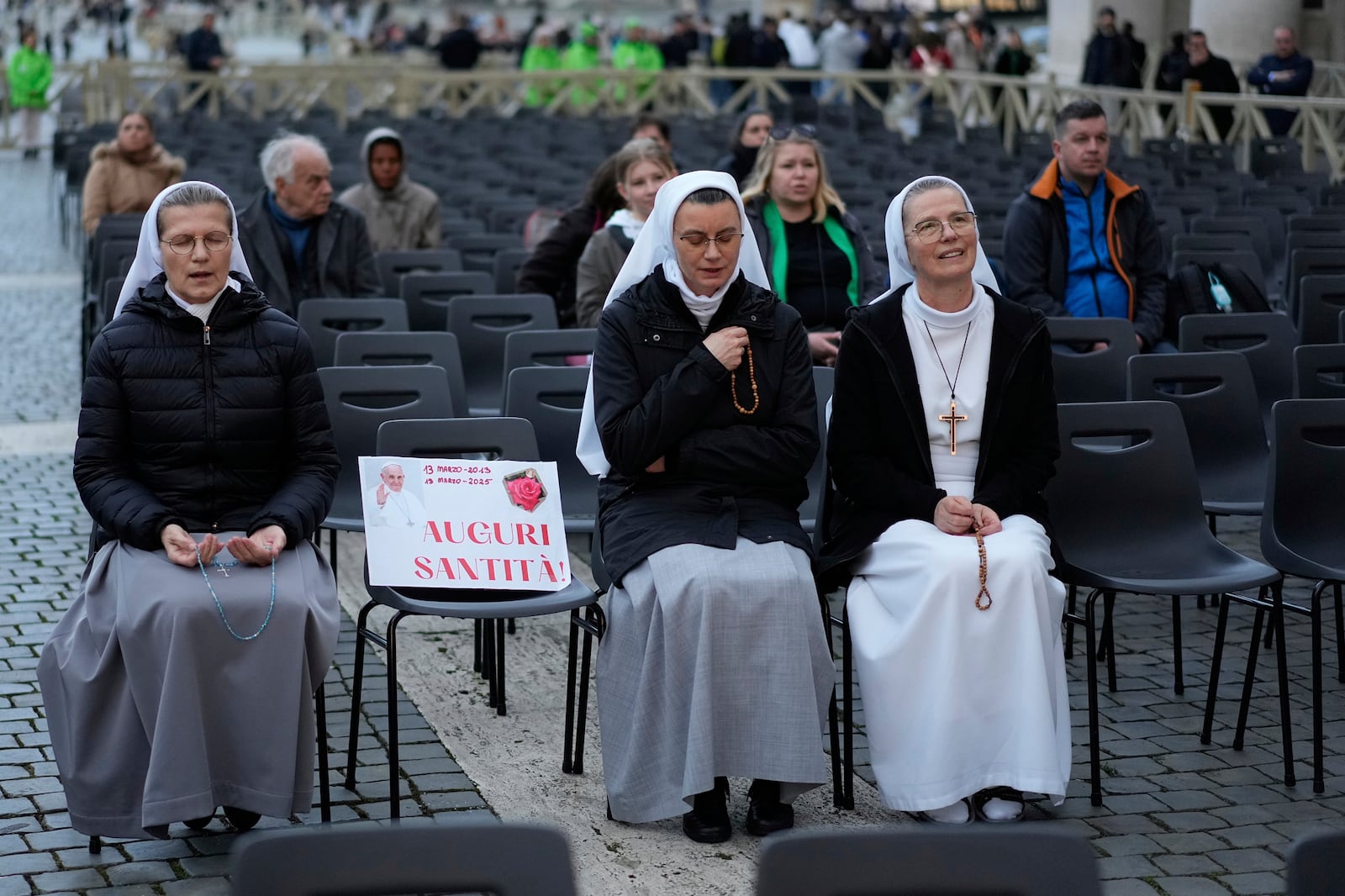 People pray in St. Peter's Square at the Vatican for the start of a vigil rosary for the recovery of Pope Francis who is being treated for pneumonia at Rome's Agostino Gemelli Polyclinic, Thursday, March 13, 2025. (AP Photo/Gregorio Borgia)