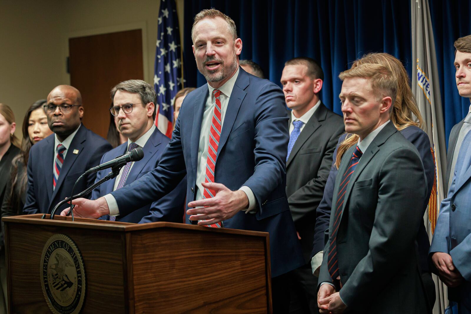 Assistant U.S. Attorney Joe Thompson, center, answers questions during a press conference at the Minneapolis federal courthouse, Wednesday, March 19, 2025, in Minneapolis, after a jury found the alleged ringleader of a massive pandemic fraud case guilty on all counts Wednesday for her role in a scheme that federal prosecutors say stole $250 million from a program meant to feed children in need. (Kerem Yücel/Minnesota Public Radio via AP)