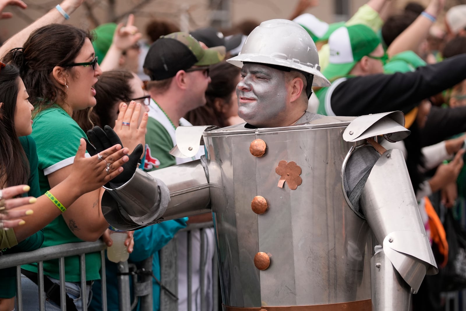 A sheet metal worker high-fives the crowd during the St. Patrick's Day parade, Sunday, March 16, 2025, in Boston, Mass. (AP Photo/Robert F. Bukaty)