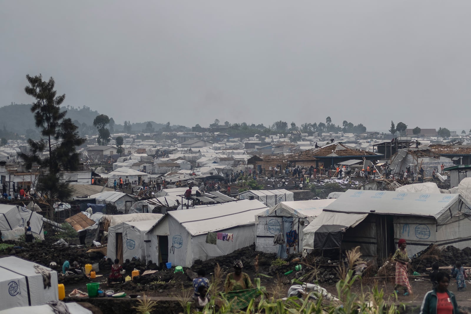 People who were displaced by the fighting between M23 rebels and government soldiers prepare to leave their camp following an instruction by M23 rebels in Goma, Democratic Republic of the Congo, Tuesday, Feb. 11, 2025. (AP Photo/Moses Sawasawa)