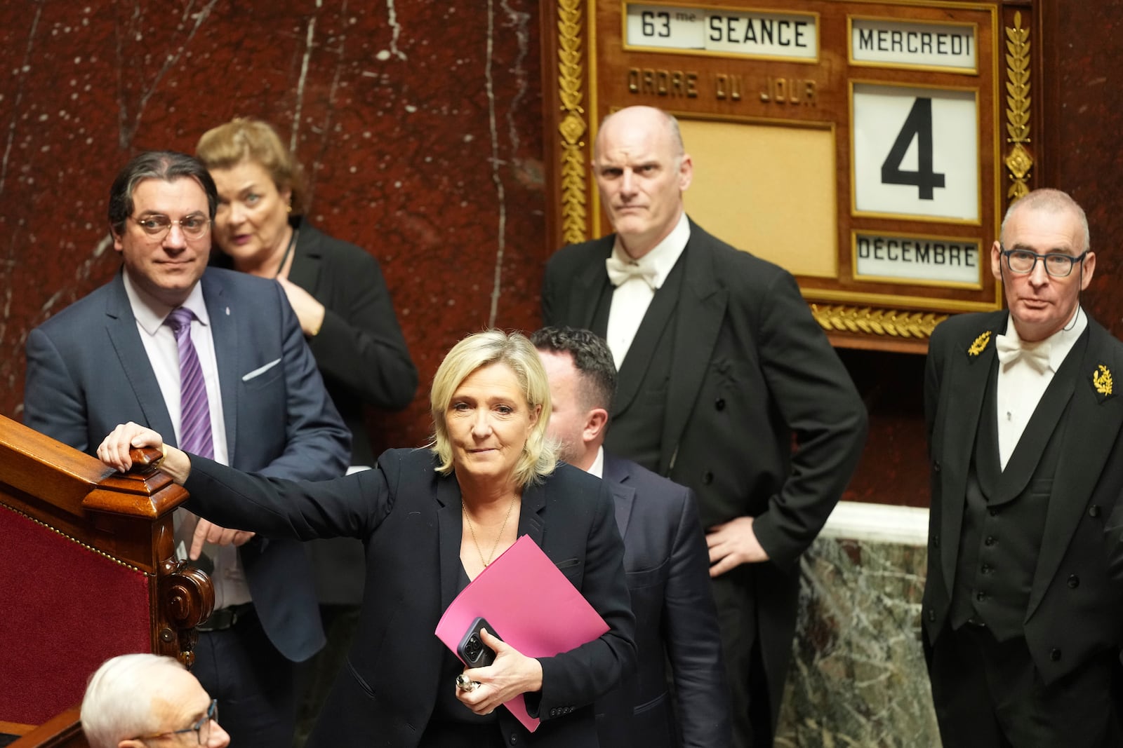 French far-right leader Marine Le Pen arrives to deliver her speech at the National Assembly prior to a no-confidence vote that could bring down the Prime Minister and the government for the first time since 1962, Wednesday, Dec. 4, 2024 in Paris. (AP Photo/Michel Euler)