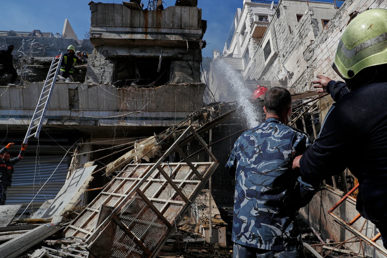 Firemen work at the site of an Israeli missile strike in Damascus, Syria, Thursday March 13, 2025.(AP Photo/Omar Sanadiki)