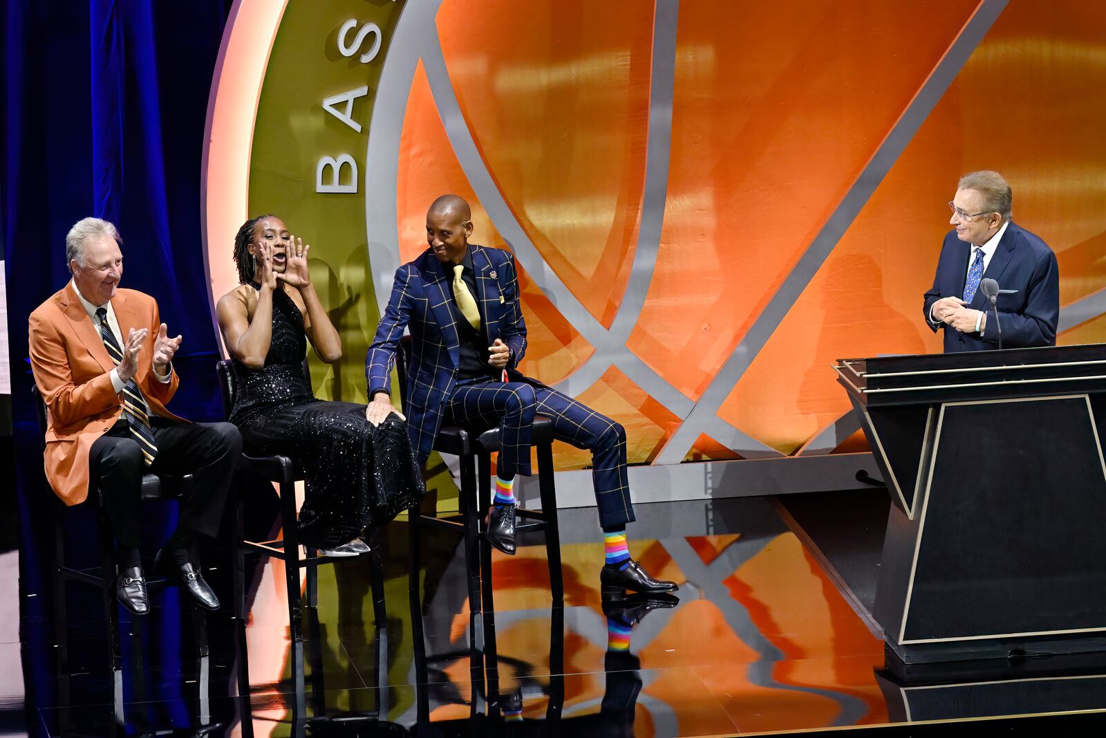 Tamika Catchings, second from left, yells out as Larry Bird, left, Reggie Miller and Herb Simon, right, look on during Simon's enshrinement at the Basketball Hall of Fame, Sunday Oct. 13, 2024, in Springfield, Mass. (AP Photo/Jessica Hill)