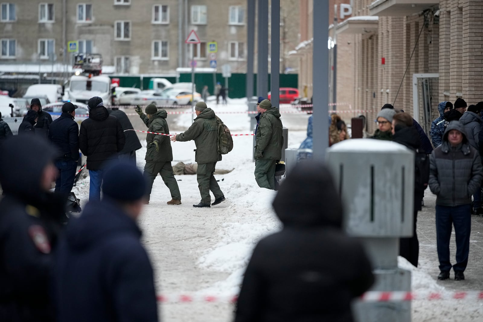 Investigates work at the place where Lt. General Igor Kirillov, the head of Russia's Nuclear, Biological, and Chemical Defence Forces was killed by an explosive device planted close to a residential apartment's block in Moscow, Russia, Tuesday, Dec. 17, 2024. (AP Photo)