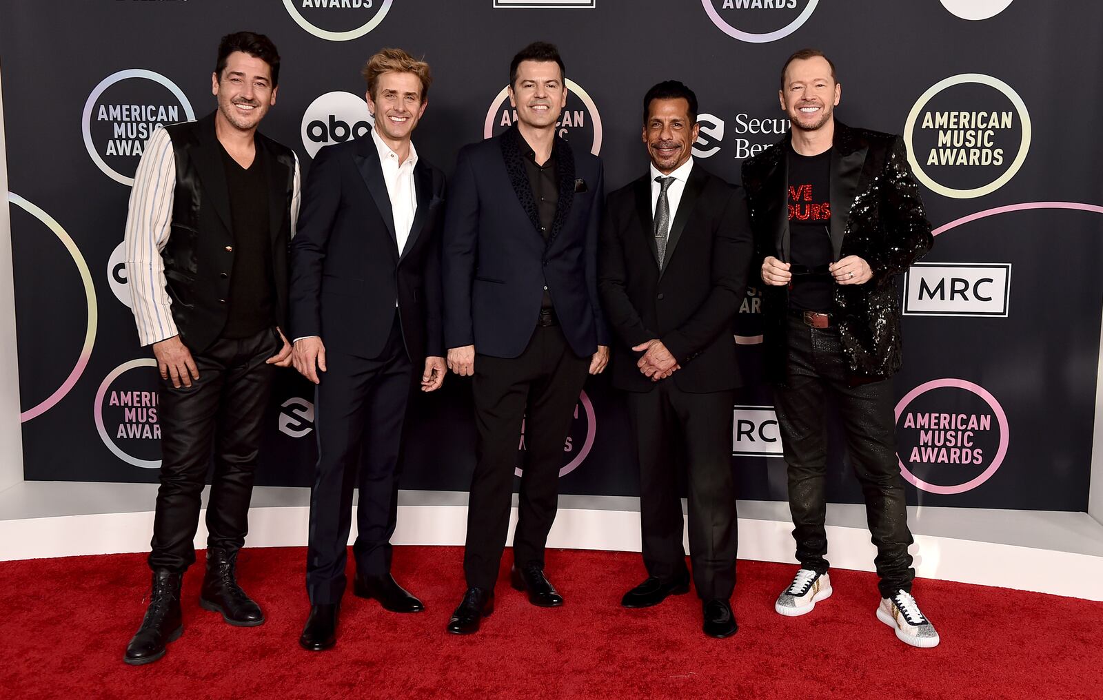 Jonathan Knight, from left, Joey McIntyre, Jordan Knight, Danny Wood and Donnie Wahlberg of New Kids On The Block arrive at the American Music Awards on Sunday, Nov. 21, 2021, at Microsoft Theater in Los Angeles. (Photo by Jordan Strauss/Invision/AP). The band will be playing a show in Columbus on June 25