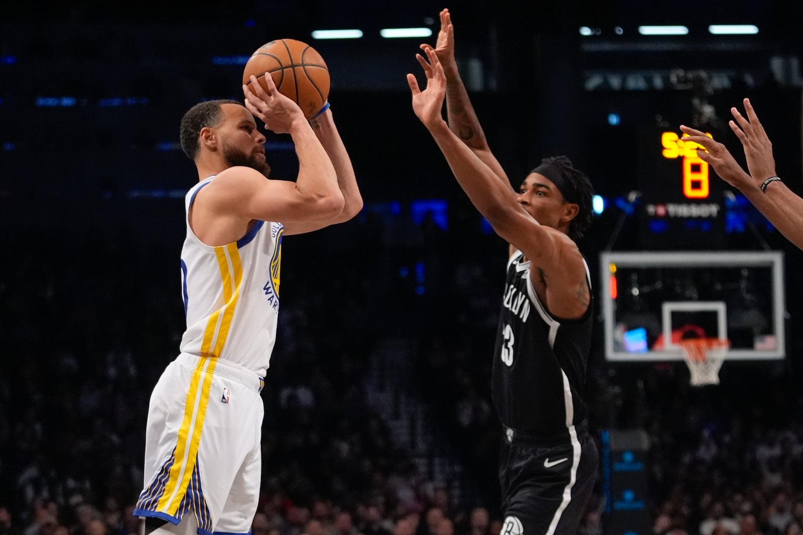 Golden State Warriors' Stephen Curry (30) shoots a three-point shot over Brooklyn Nets' Nic Claxton (33) during the second half of an NBA basketball game Thursday, March 6, 2025, in New York. (AP Photo/Frank Franklin II)