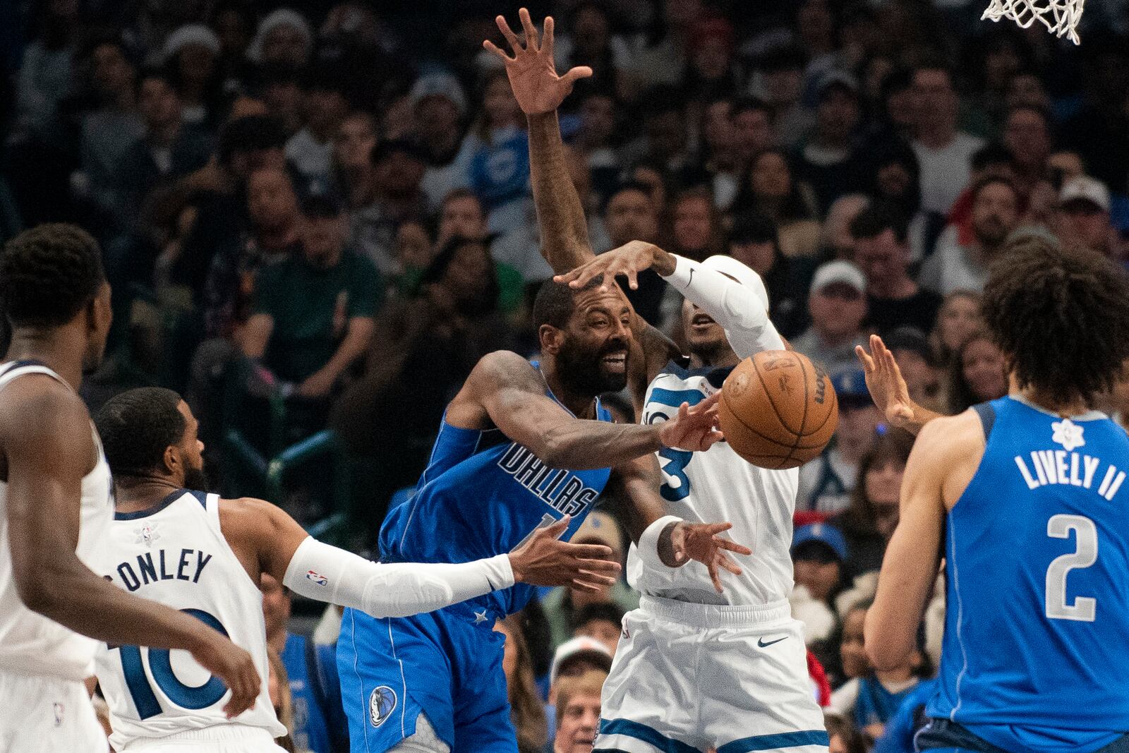 Dallas Mavericks guard Kyrie Irving (11) attempts to pass the ball to Dallas Mavericks center Dereck Lively II (2) in the first half of an NBA basketball game against the Minnesota Timberwolves on Wednesday, Dec. 25, 2024, in Dallas. (AP Photo/Emil T. Lippe)