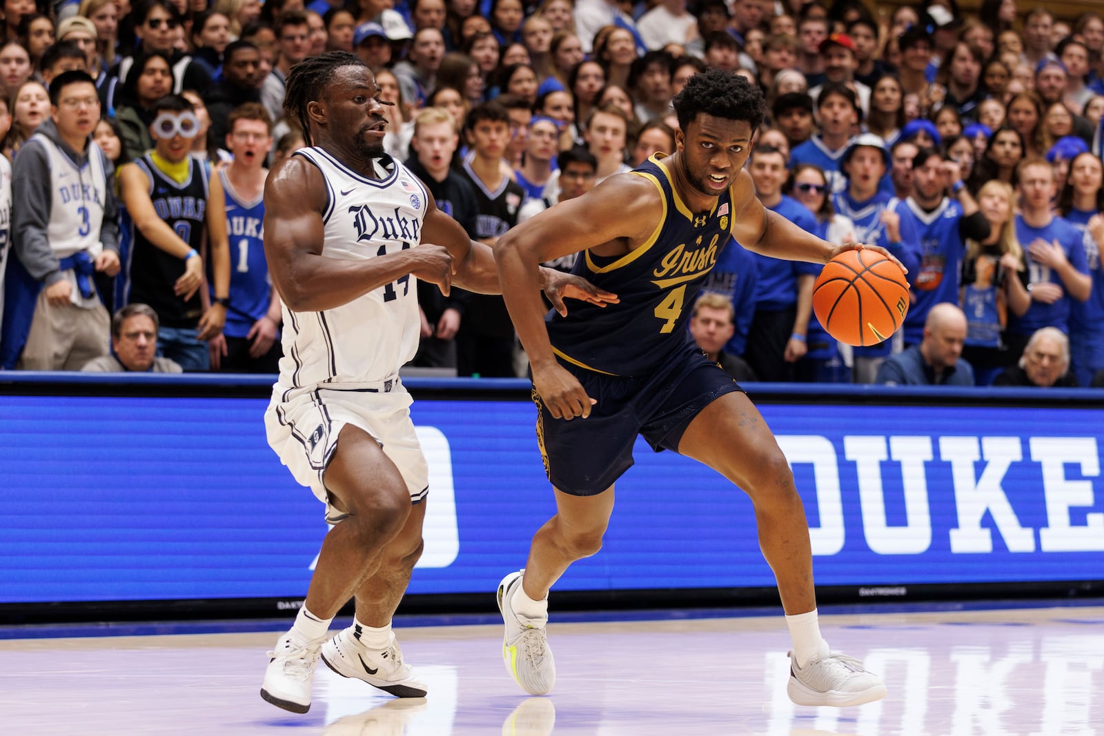 Notre Dame's Sir Mohammed (4) drives as Duke's Sion James (14) defends during the first half of an NCAA college basketball game in Durham, N.C., Saturday, Jan. 11, 2025. (AP Photo/Ben McKeown)