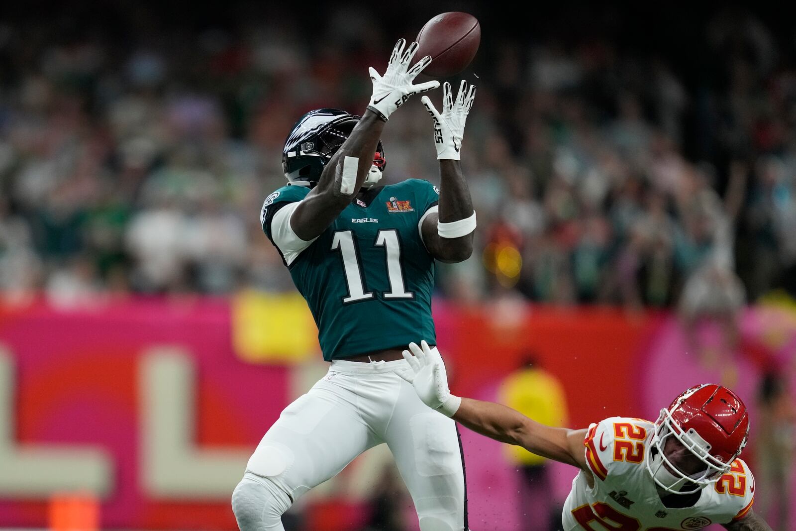 Philadelphia Eagles wide receiver A.J. Brown (11) pulls in a pass as Kansas City Chiefs cornerback Trent McDuffie (22) defends during the first half of the NFL Super Bowl 59 football game, Sunday, Feb. 9, 2025, in New Orleans. (AP Photo/Ashley Landis)