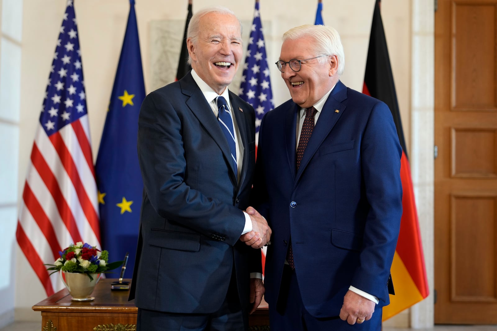 President Joe Biden, left, is greeted by German President Frank-Walter Steinmeier during the welcoming ceremony at Bellevue Palace in Berlin, Germany, Friday, Oct. 18, 2024. (AP Photo/Ben Curtis)