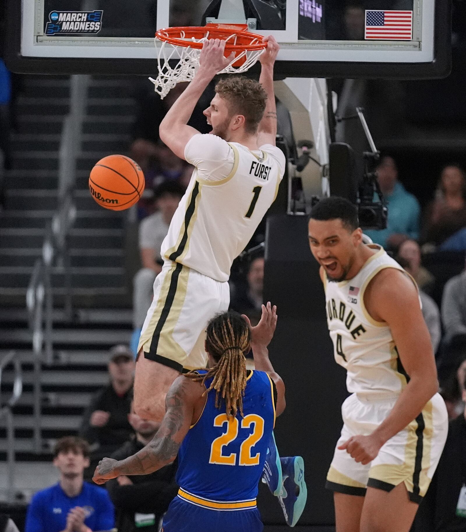 Purdue forward Caleb Furst (1) celebrates on a dunk against McNeese State during the first half in the second round of the NCAA college basketball tournament, Saturday, March 22, 2025, in Providence, R.I. (AP Photo/Charles Krupa)