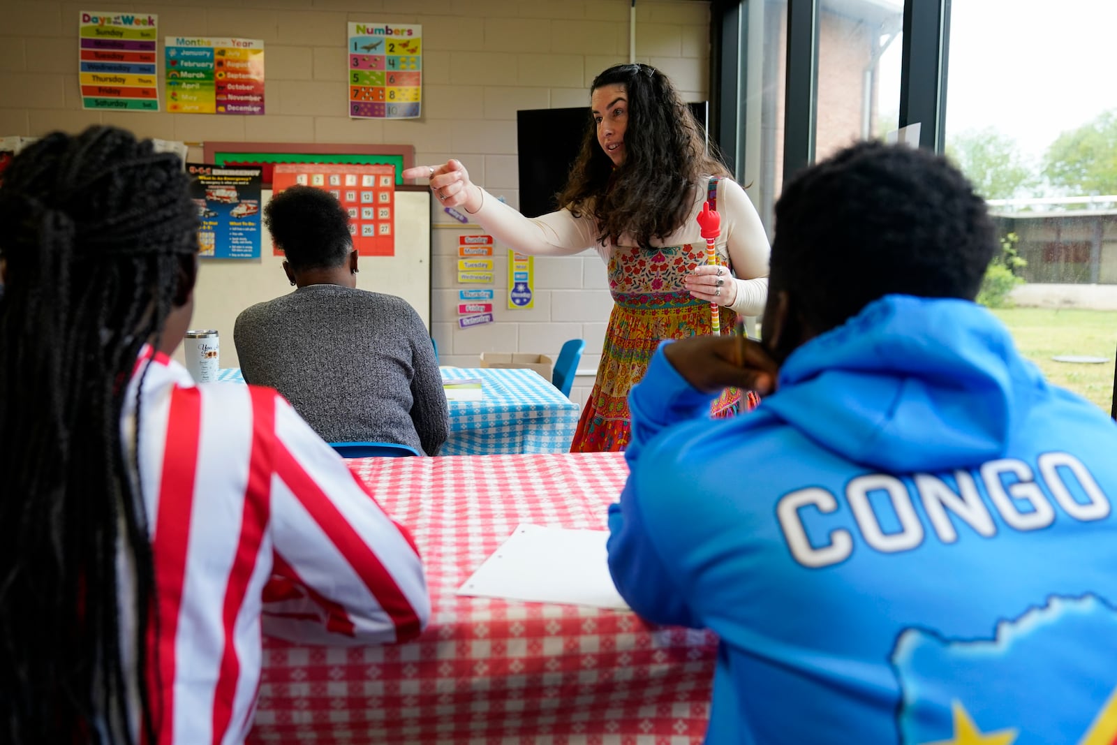 FILE - Lutheran Services Carolinas outreach coordinator supervisor Sarah Lewis, center, teaches an English class for recently arrived refugees, April 11, 2024, in Columbia, S.C. (AP Photo/Erik Verduzco, File)