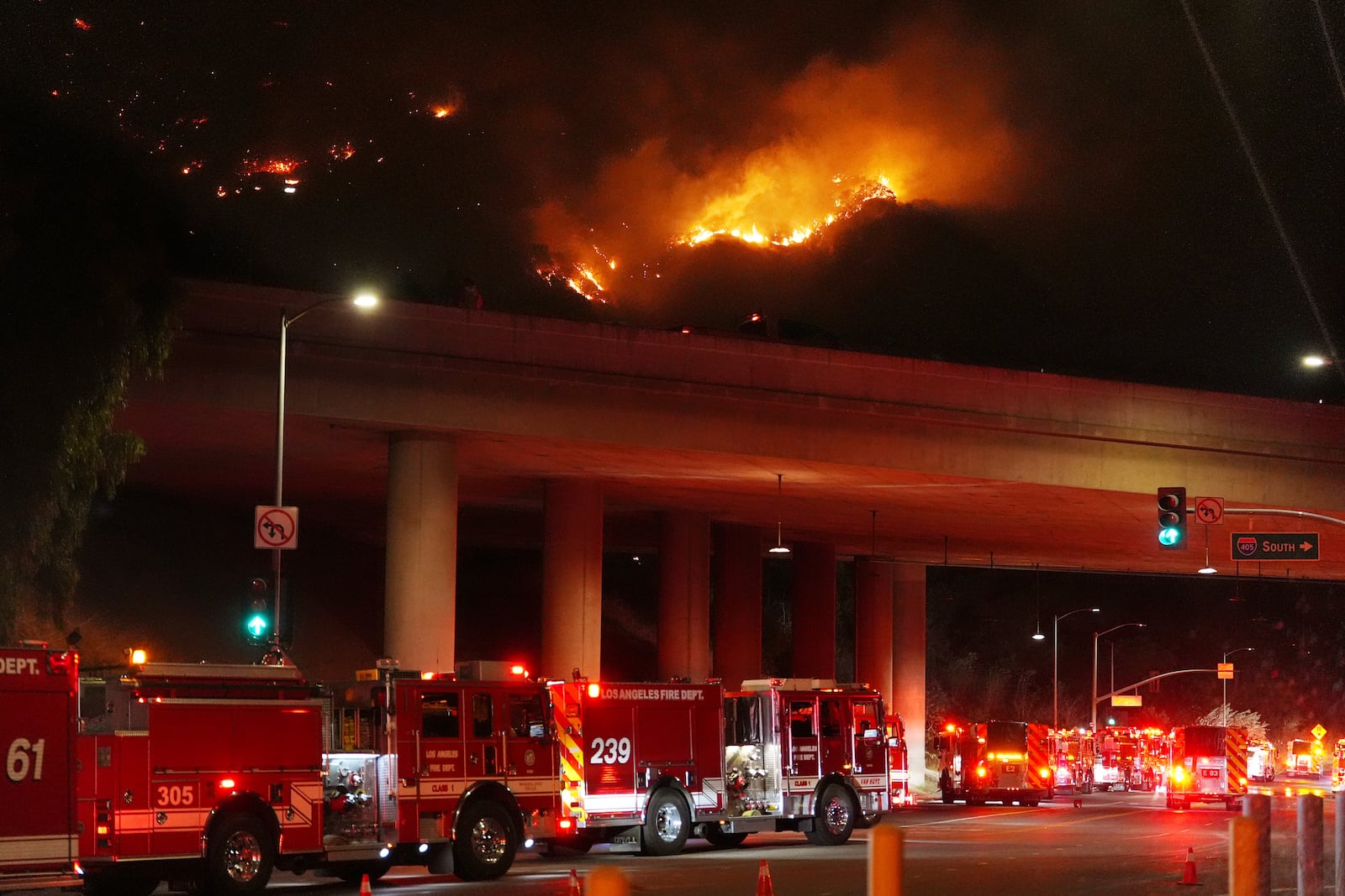 Apparatus sits on Sepulveda Blvd. as fire burns along Interstate 405, Thursday, Jan. 23, 2025, in Los Angeles. (AP Photo/Mark J. Terrill)