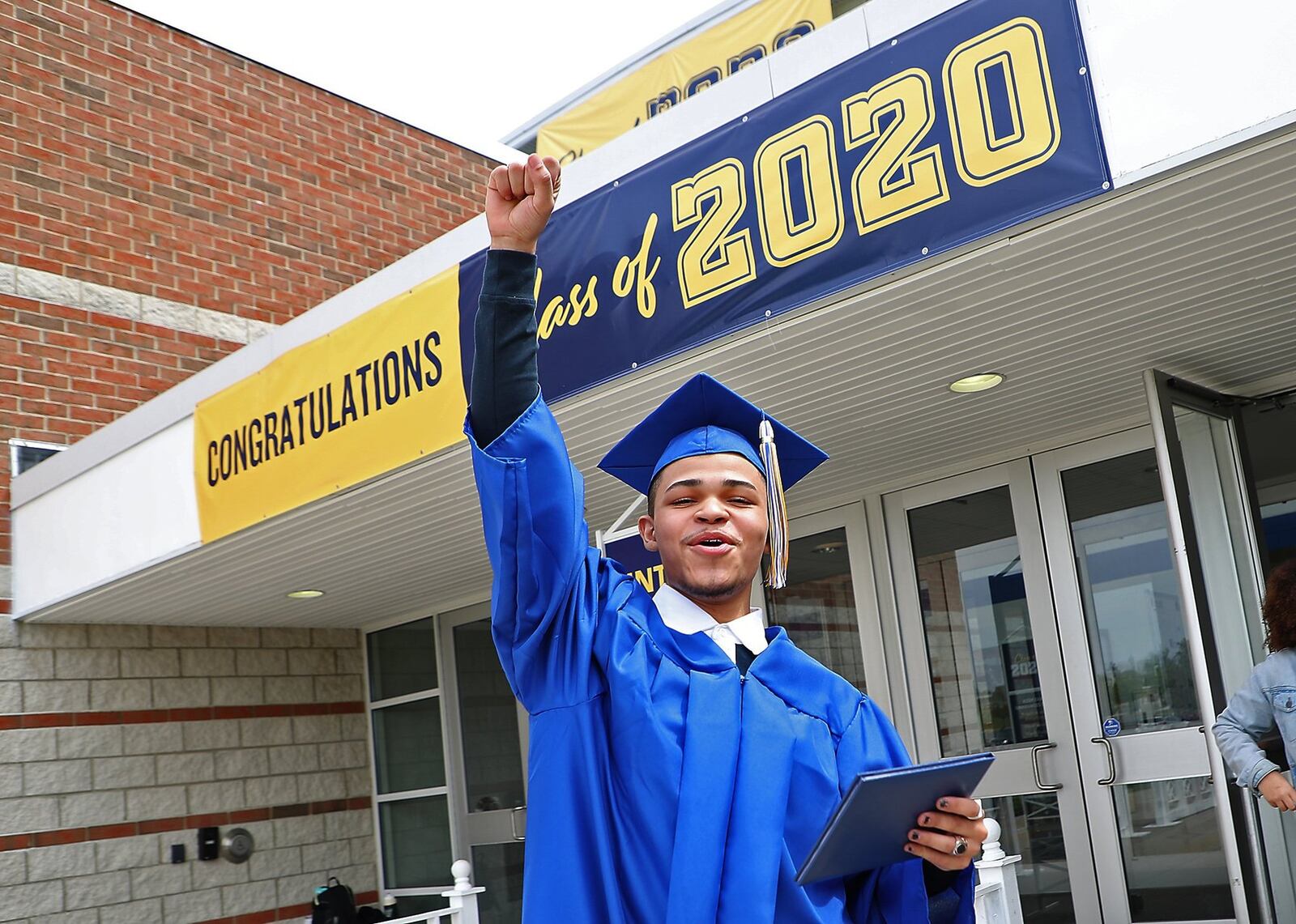 Delvin Bishop celebrates outside Springfield High School Thursday after receiving his diploma in an individual ceremony in the school’s gymnasium. BILL LACKEY/STAFF