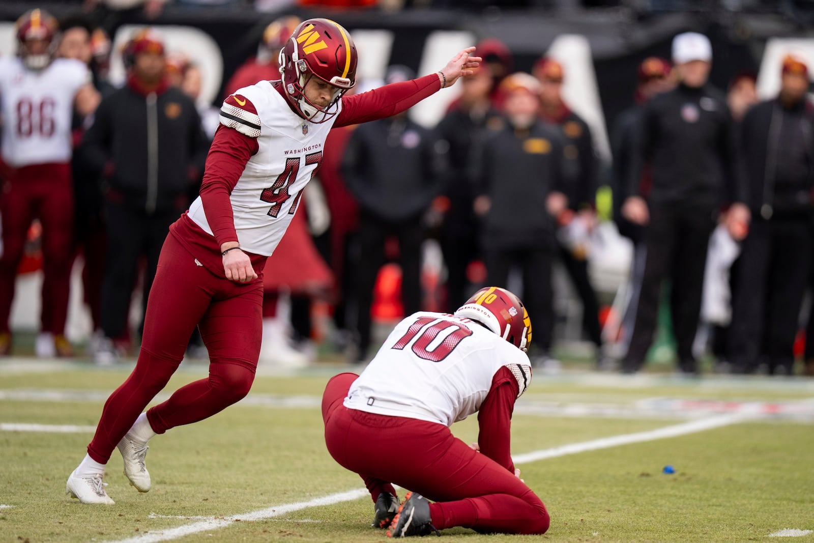 Washington Commanders kicker Zane Gonzalez (47) kicks the field goal with punter Tress Way (10) holding during the NFL championship playoff football game against the Philadelphia Eagles, Sunday, Jan. 26, 2025, in Philadelphia. (AP Photo/Chris Szagola)