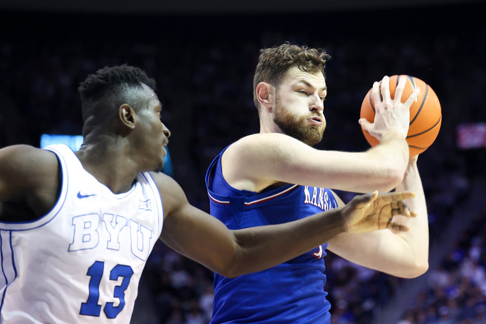 BYU center Keba Keita (13) and Kansas center Hunter Dickinson battle for a rebound during the second half of an NCAA college basketball game, Tuesday, Feb. 18, 2025, in Provo, Utah. (AP Photo/Rob Gray)