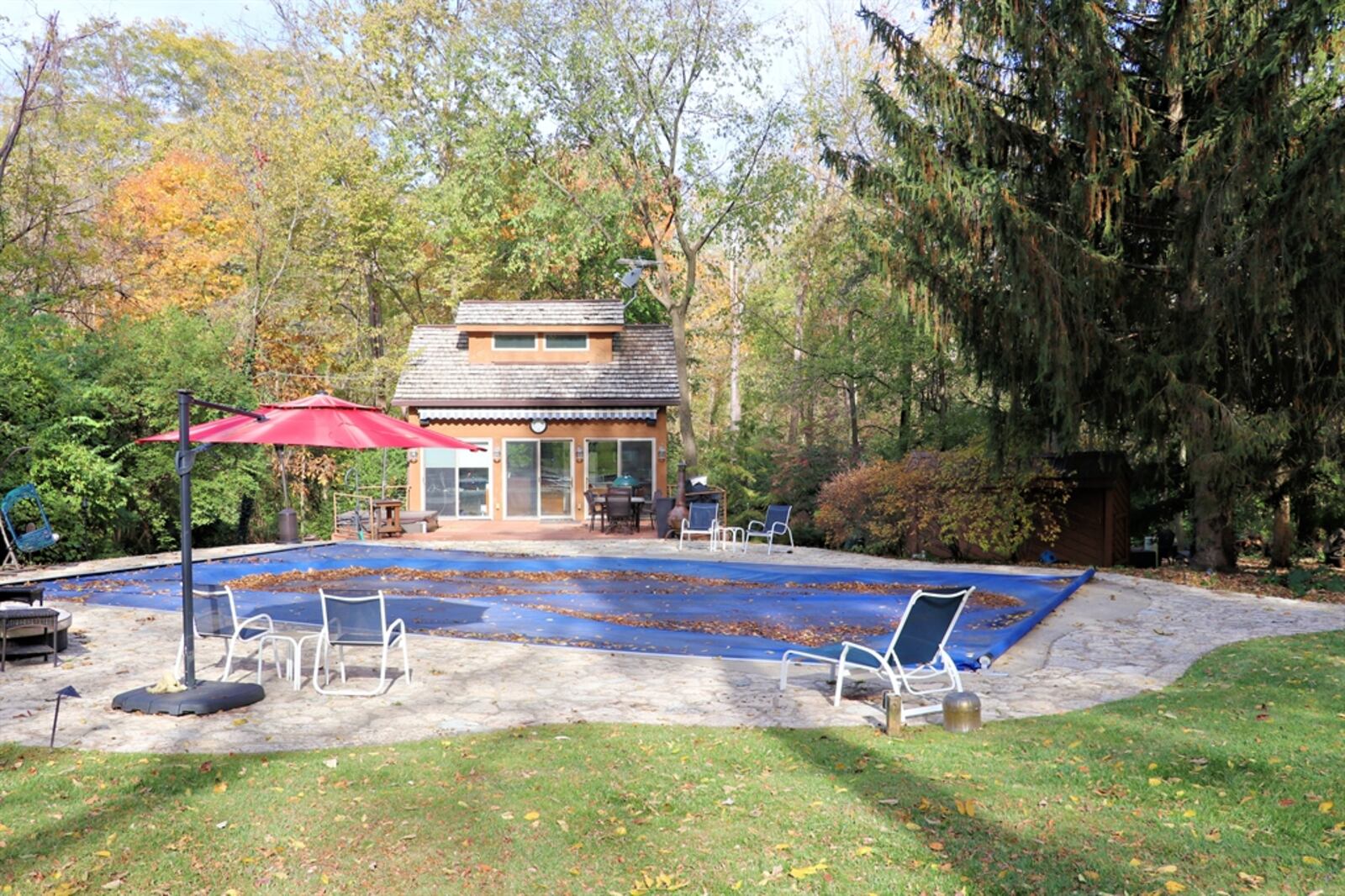 A composite deck extension from the pool surround has a built-in hot tub, and outdoor shower and sliding patio entrance to the pool house, which offers an equipped kitchenette with bar seating, a wet bar with beverage cooler, a family room, a loft bedroom and a full bathroom. Contributed photo by Kathy Tyler