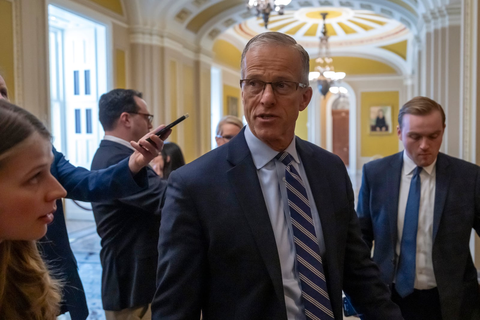 Senate Majority Leader Sen. John Thune, R-S.D., walks to the Senate chamber as the Senate works to avert a partial government shutdown ahead of the midnight deadline, at the Capitol in Washington, Friday, March 14, 2025. (AP Photo/Ben Curtis)