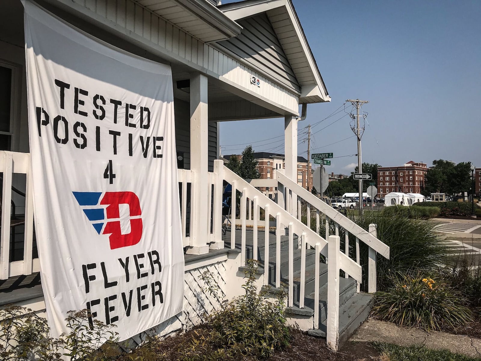 Students at the University of Dayton on campus housing hung a banner on their front porch related to the COVID-19 outbreak. Jim Noelker/Staff