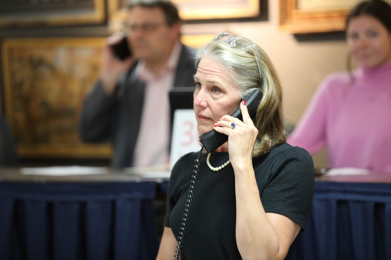 Lauren Brunk waits to see if a bidder on the phone wants to make a bid during an auction that included a 1787 copy of the U.S. Constitution that sold for $9 million at Brunk Auctions in Asheville, N.C., on Thursday, Oct. 17, 2024. (AP Photo/Jeffrey Collins)