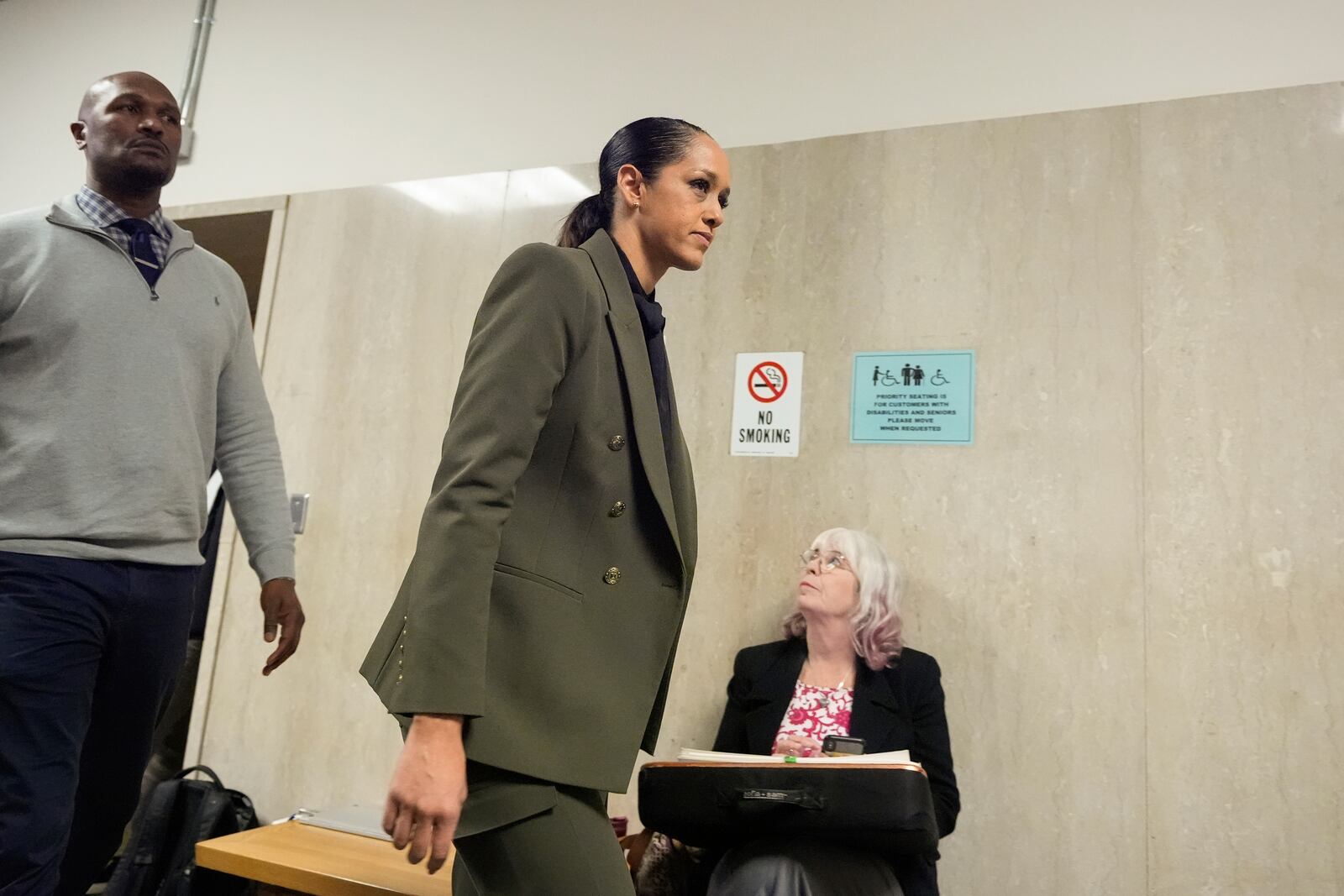 San Francisco district attorney Brooke Jenkins, second from left, walks out of the courtroom at the Hall of Justice for the murder trial of Nima Momeni, Monday, Dec. 2, 2024, in San Francisco. (AP Photo/Godofredo A. Vásquez)