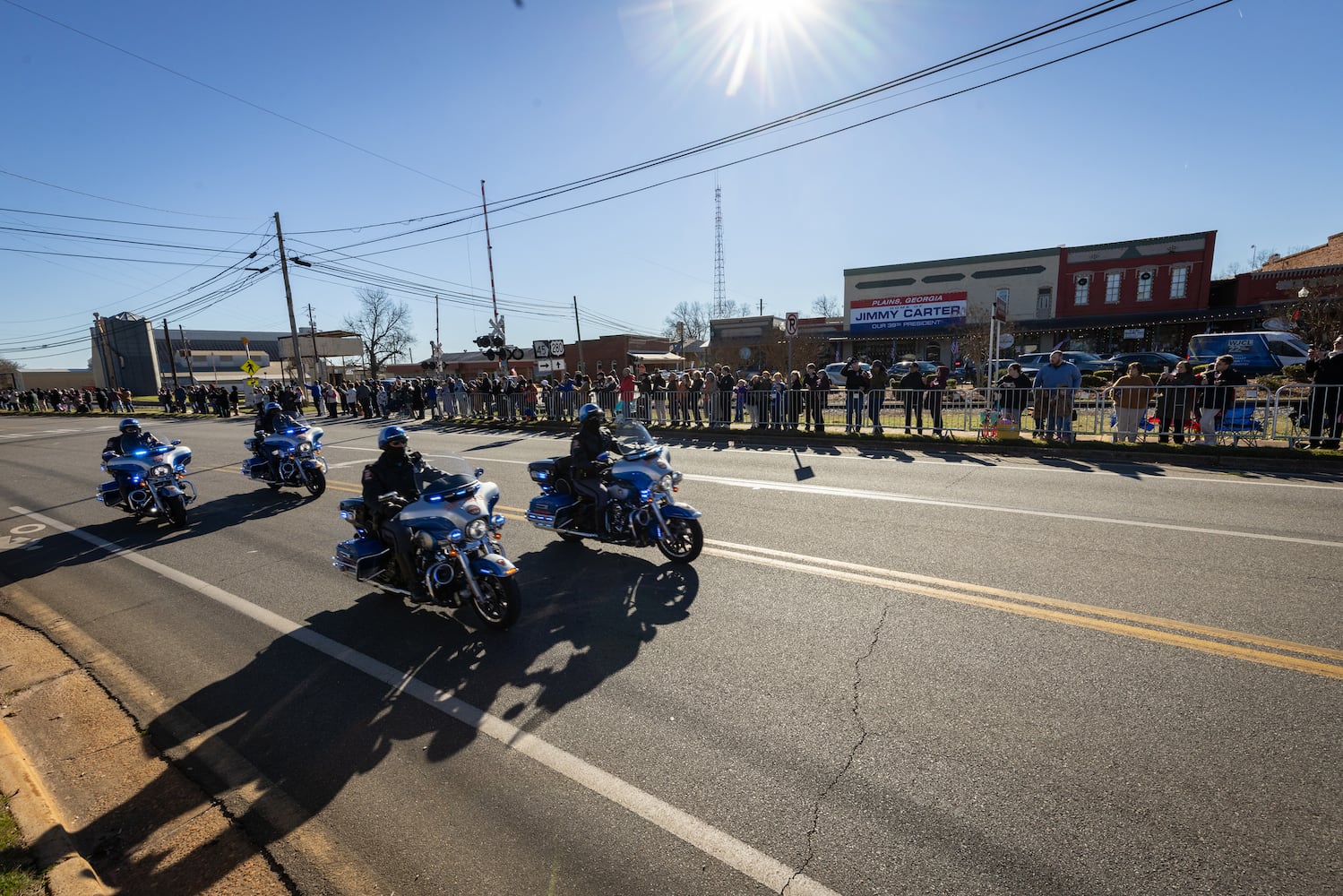 A police escort passes as the hearse carrying the casket of former President Jimmy Carter moves through Plains, Ga., Saturday, Jan. 4, 2025. (Dustin Chambers/The New York Times)