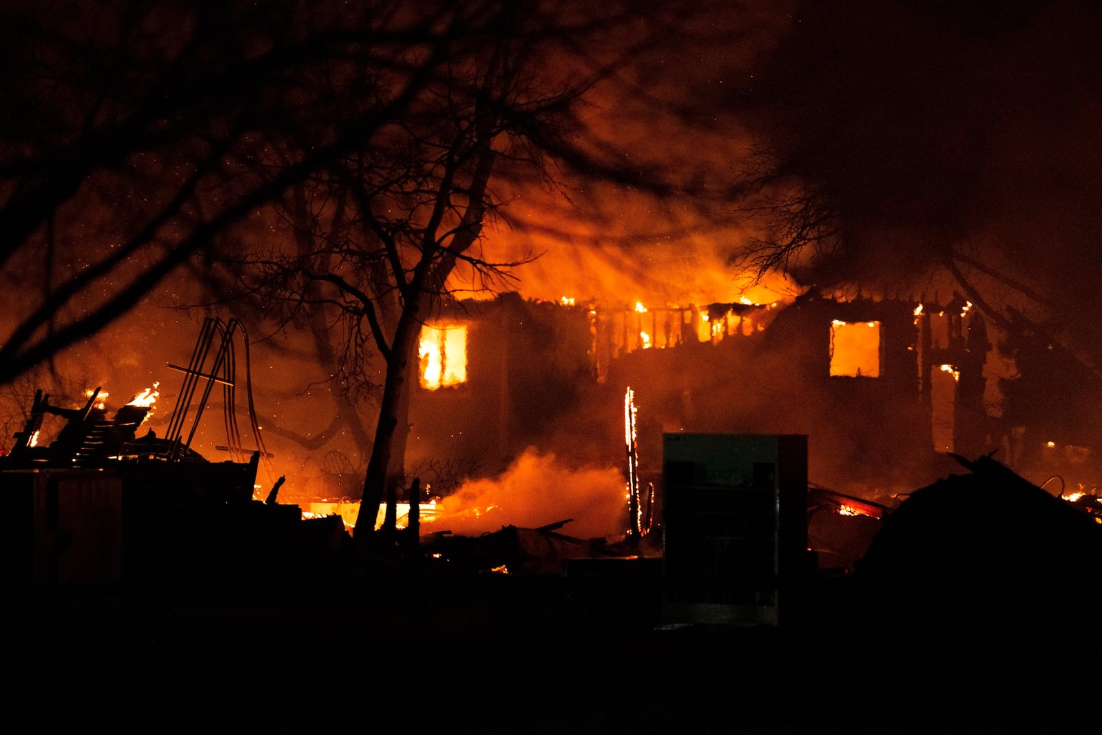 FILE - The Marshall Fire engulfs a home in Louisville, Colo., Thursday, Dec. 30, 2021, as crews worked through the night battling the blaze. (Christian Murdock/The Gazette via AP, File)