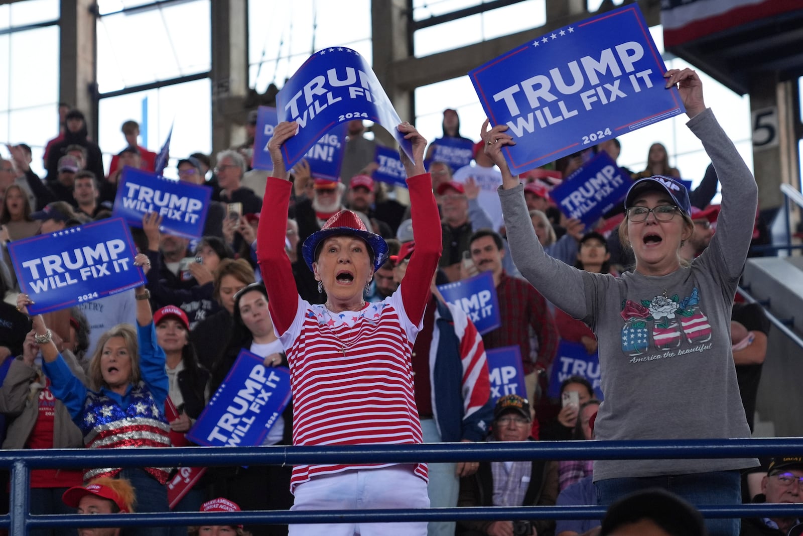 Supporters get ready before Republican presidential nominee former President Donald Trump arrives to speak to a campaign rally at J.S. Dorton Arena, Monday, Nov. 4, 2024, in Raleigh, N.C. (AP Photo/Evan Vucci)