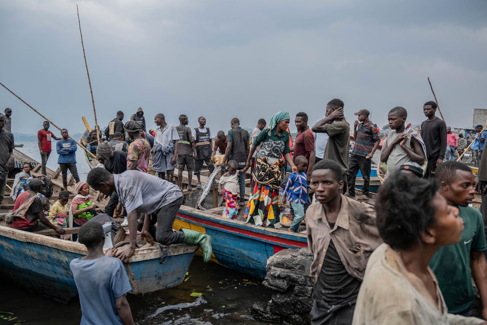 People fleeing M-23 rebel advances arrive by boat in Goma, Democratic Republic of the Congo, Wednesday, Jan. 22, 2025. (AP Photo/Moses Sawasawa)