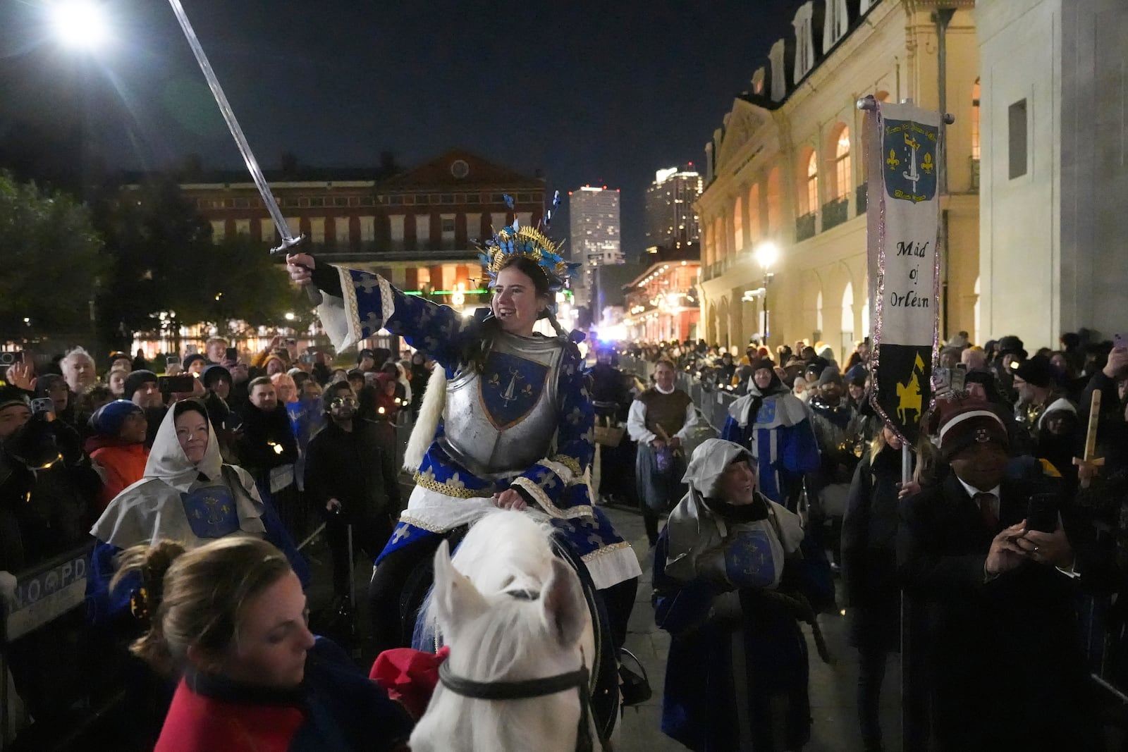 A person dressed as Joan of Arc holds a sword on-top of a horse during the annual Krewe de Jeanne d'Arc parade, kicking off the Mardi Gras season, in New Orleans, Monday, Jan. 6, 2025. (AP Photo/Gerald Herbert)