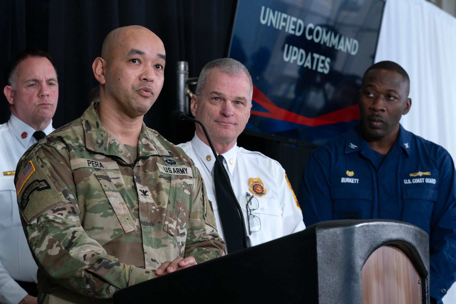 Col. Francis Pera, commander of the U.S. Army Corps of Engineers, from left, speaks as D.C. Fire and EMS Chief John Donnelly and U.S. Coast Guard Captain Patrick Burkett listen during a news conference at Ronald Reagan Washington National Airport, Sunday, Feb. 2, 2025, in Arlington, Va. (AP Photo/Jose Luis Magana)