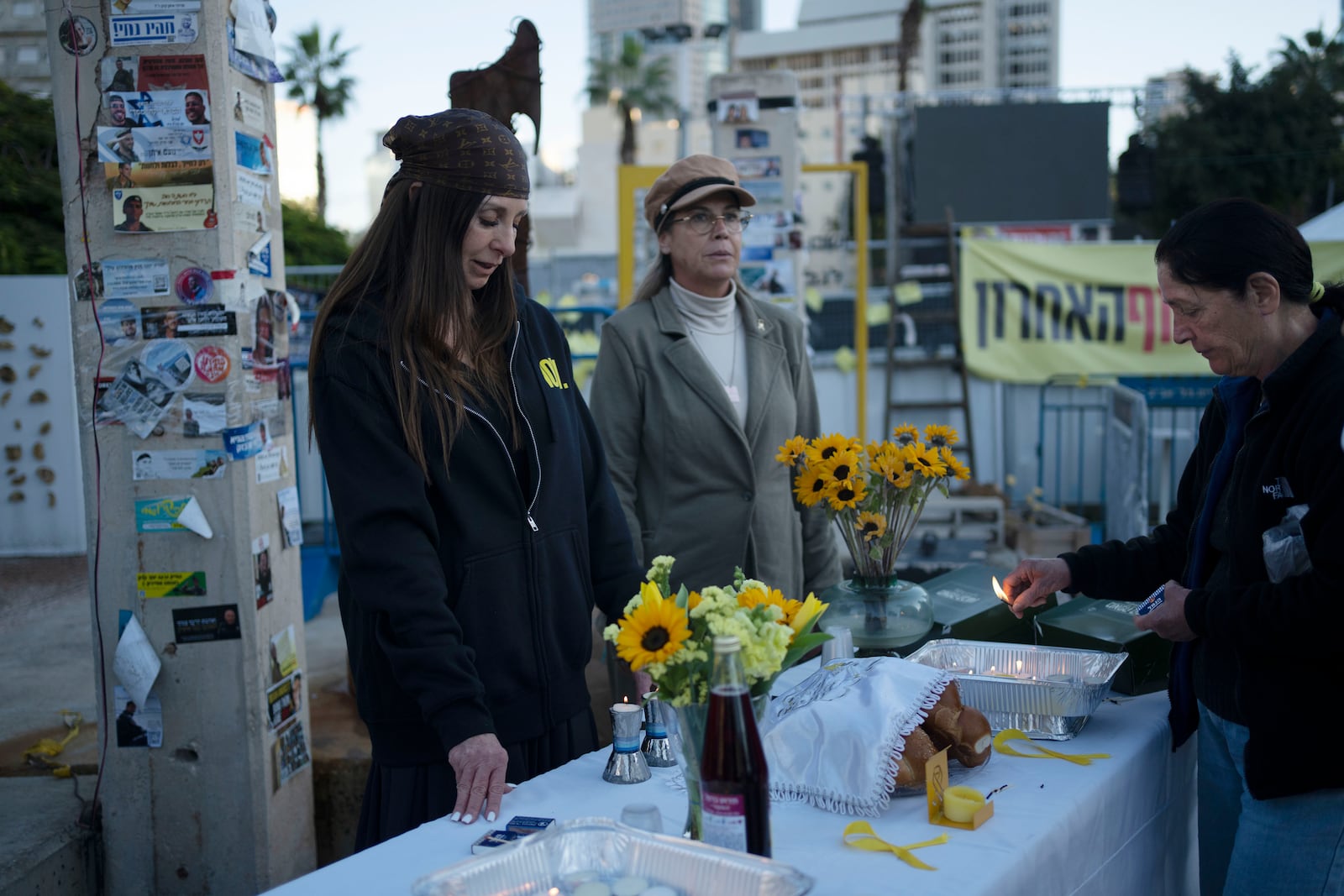 Relatives and supporters of hostages held by the Hamas militant group in the Gaza Strip mark the start of Shabbat in Tel Aviv, Israel, Friday, Jan. 24, 2025. (AP Photo/Maya Alleruzzo)