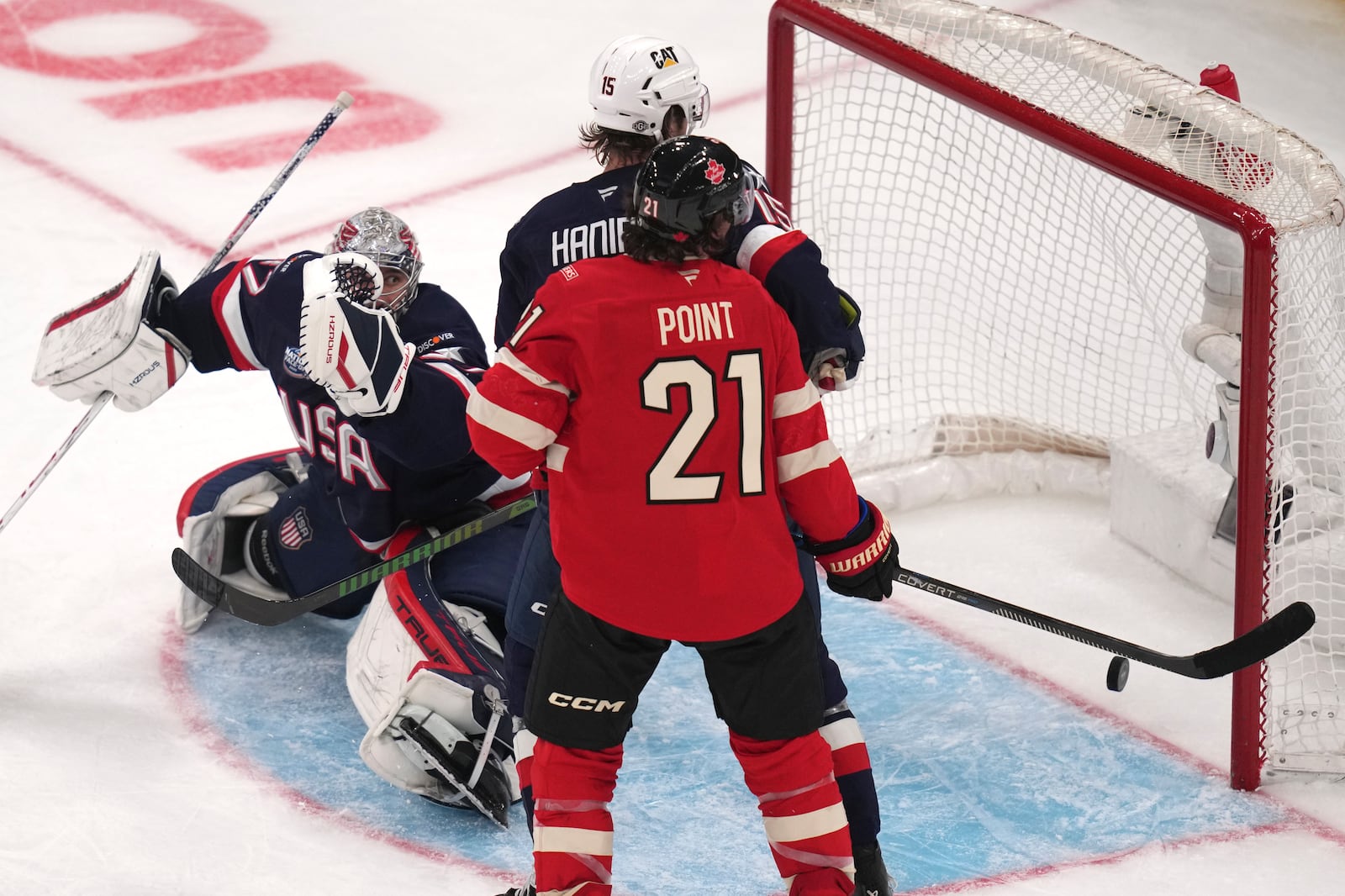 United States goalie Connor Hellebuyck, left, gives up the winning goal to Canada's Connor McDavid (not shown) during an overtime period of the 4 Nations Face-Off championship hockey game, Thursday, Feb. 20, 2025, in Boston. (AP Photo/Charles Krupa)