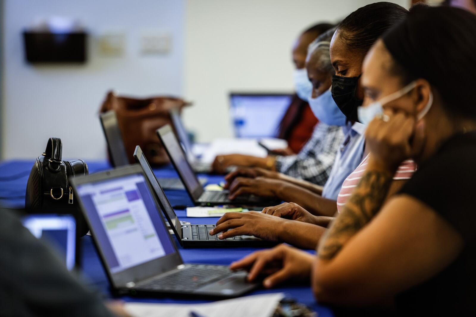 Potential Dayton Public Schools employees complete job applications at a job fair Wednesday Sept. 29, 2021. JIM NOELKER/STAFF