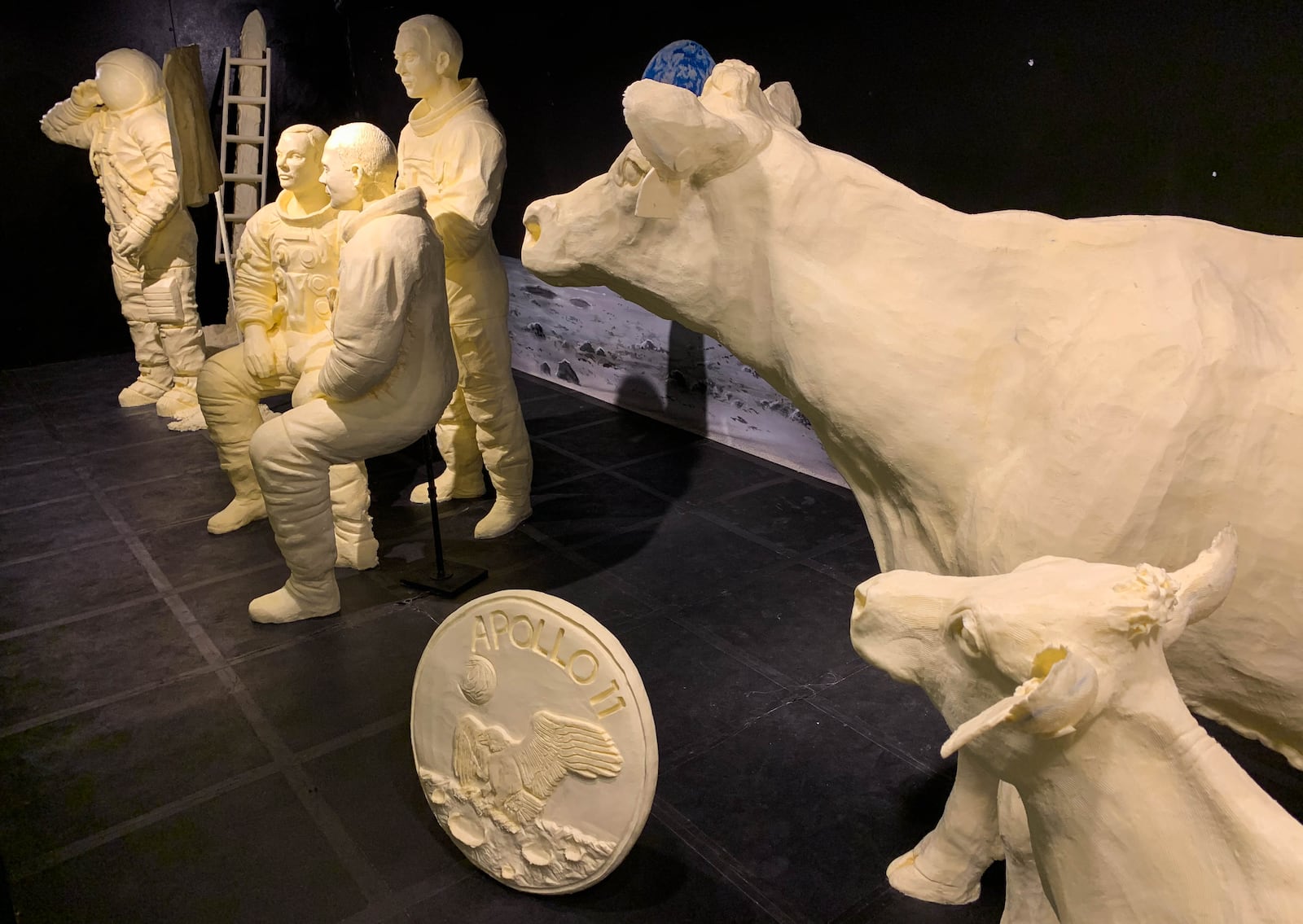 The annual butter display honors the 50th anniversary of the first moon landing and includes sculptures of Neil Armstrong saluting the American flag next to the lunar module, the full Apollo 11 crew, the official Apollo 11 patch and the traditional butter cow and calf. CONTRIBUTED BY THE OHIO STATE FAIR