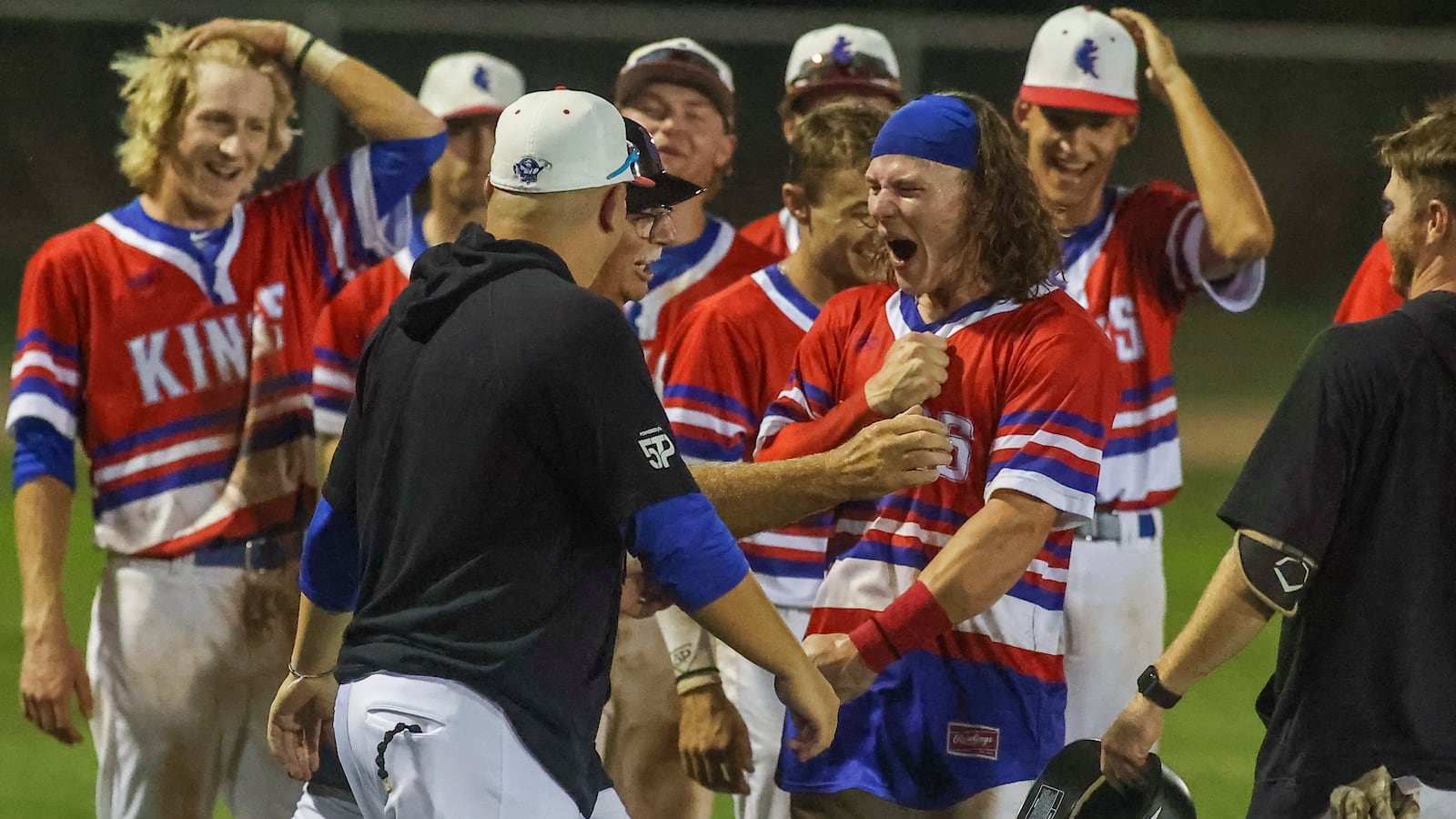 Champion City Kings catcher Bo Seccombe celebrates with Kings assistant coach Mark Lucas and manager Gavin Murphy after the Kings 10-9 playoff victory over the Chillicothe Paints on Aug. 4 at Carleton Davidson Stadium. Michael Cooper/CONTRIBUTED