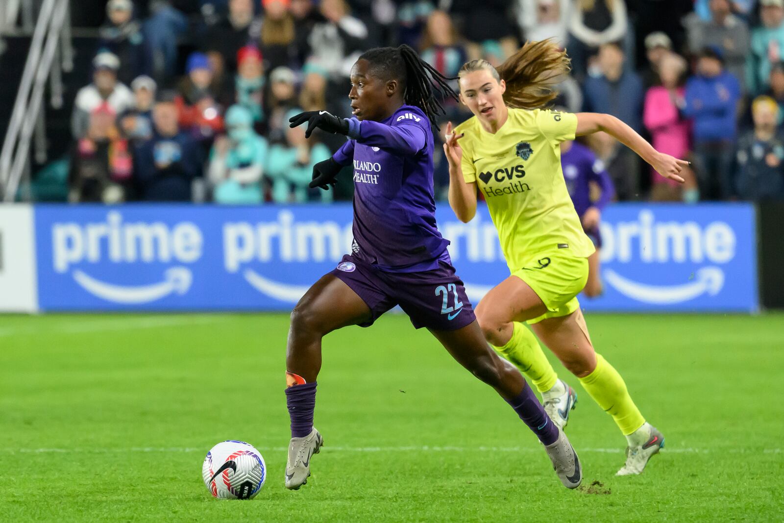 Orlando Pride forward Barbra Banda (22) runs past Washington Spirit defender Tara McKeown (9) during the second half of the NWSL championship at CPKC Stadium, Saturday, November 23, 2024, in Kansas City, Mo. (AP Photo/Reed Hoffmann)