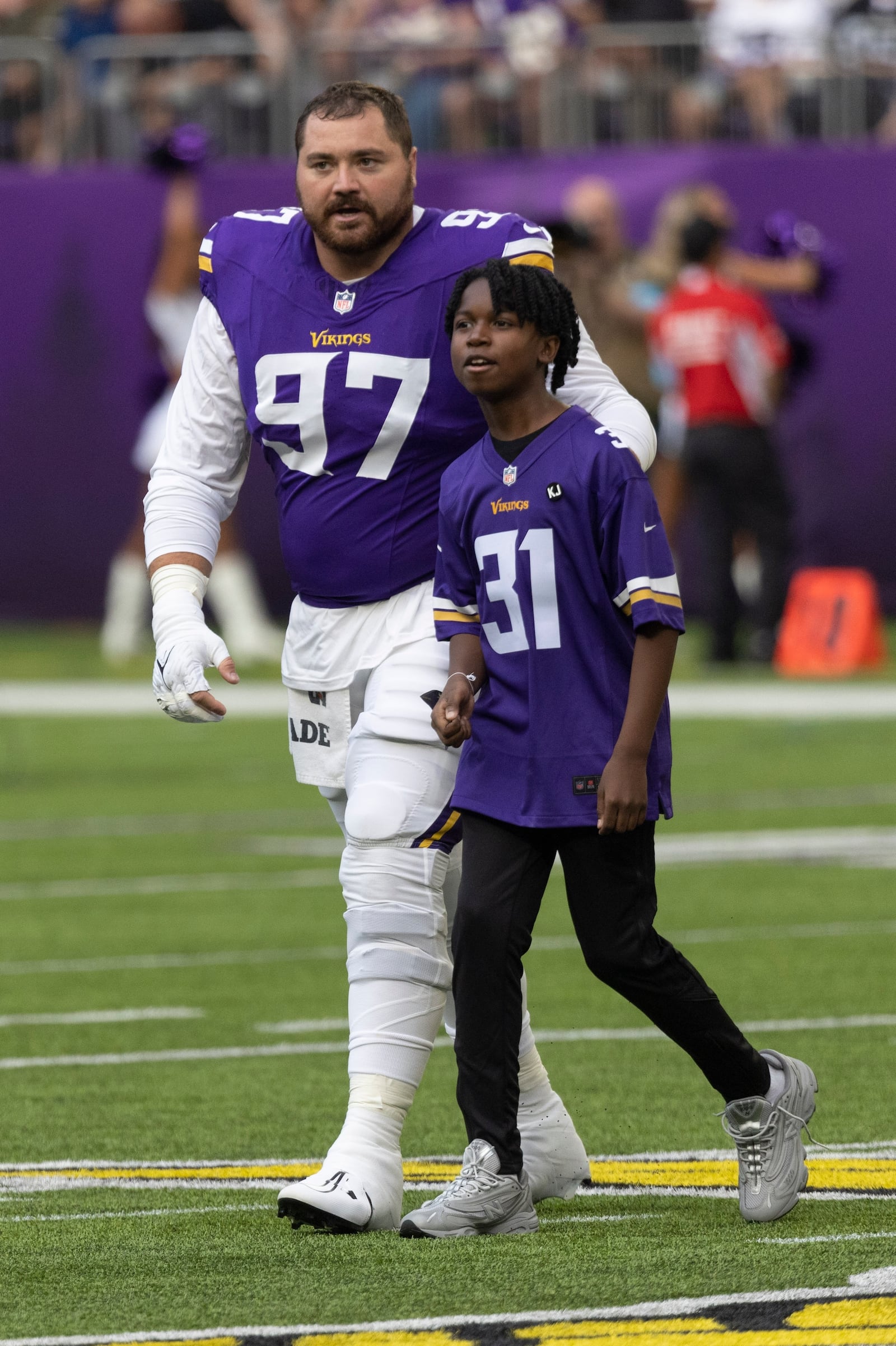 FILE - Former Minnesota Vikings rookie Khyree Jackson's brother Kolston Jackson (31) walks off the field for the coin toss with Minnesota Vikings defensive tackle Harrison Phillips (97) before an during an NFL preseason football game against the Las Vegas Raiders, Saturday, Aug. 10, 2024, in Minneapolis. (AP Photo/Andy Clayton-King, File)