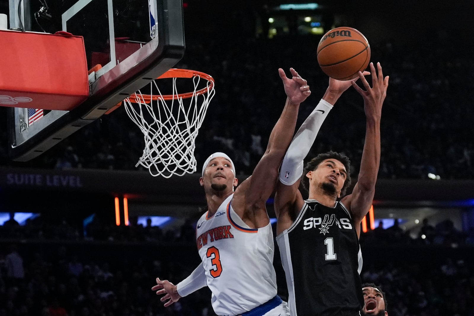 New York Knicks' Josh Hart (3), left, and San Antonio Spurs' Victor Wembanyama fight for a rebound during the second half of an NBA basketball game, Wednesday, Dec. 25, 2024, in New York. The Knicks defeated the Spurs 117-114. (AP Photo/Seth Wenig)